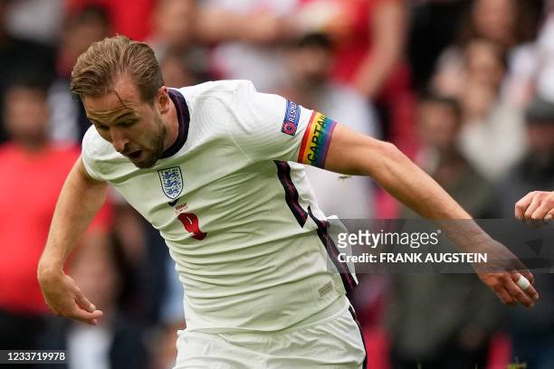 England's forward Harry Kane wears a captain's armband bearing the rainbow colours during the UEFA EURO 2020 round of 16 football match between...