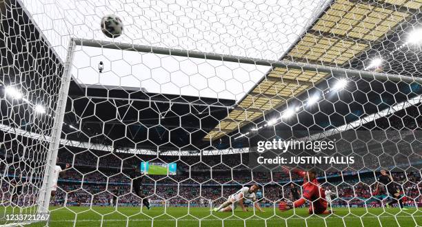 England's forward Harry Kane scores England's second goal during the UEFA EURO 2020 round of 16 football match between England and Germany at Wembley...