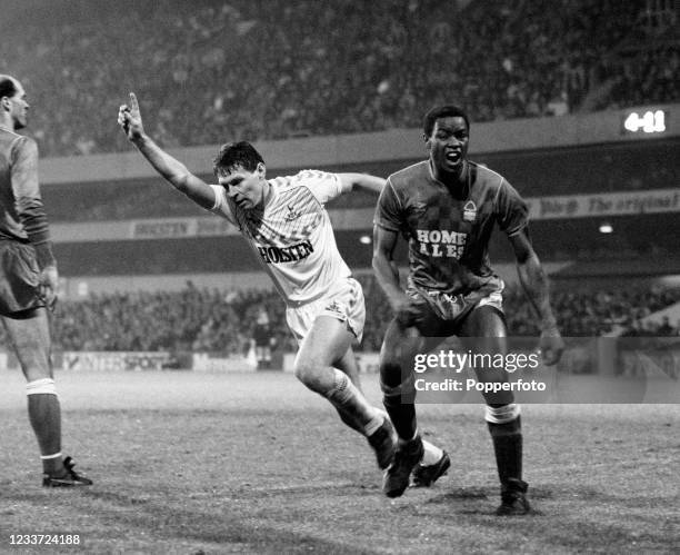 Clive Allen of Tottenham Hotspur wheels away in celebration of his goal as Chris Fairclough of Nottingham Forest reacts after conceding during a...