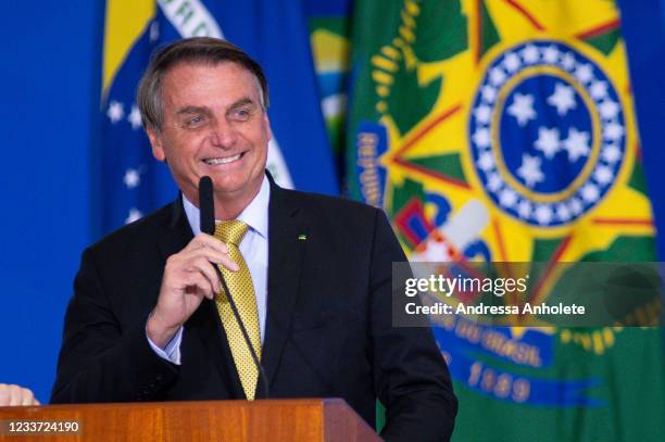 President of Brazil Jair Bolsonaro smiles during an event to launch a new register for professional workers of the fish industry at Planalto...