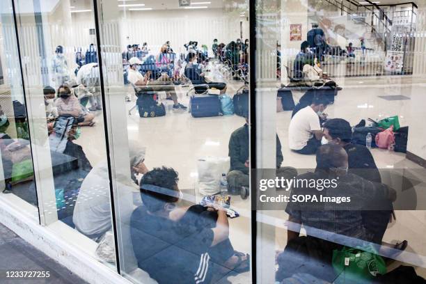 Patients with Covid-19 queue to be served by health workers inside the Wisma Atlet Covid-19 Emergency Hospital complex. Indonesia has seen a...