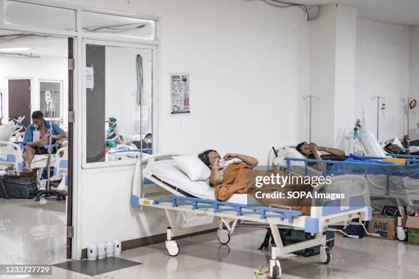 Patient with breathing difficulties uses an oxygen hose inside the Wisma Atlet Covid-19 Emergency Hospital complex. Indonesia has seen a significant...