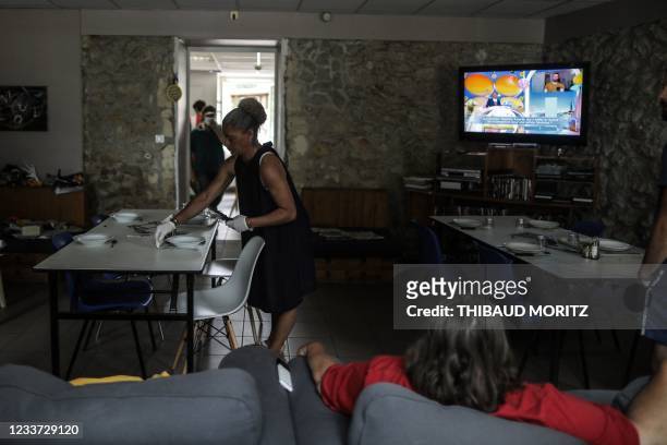 In this photograph taken on June 17 'Sylvie', a former crack addict helps to prepare the dining room for lunch at "Centre de soins, d'accompagnement...