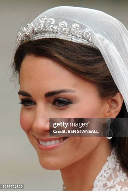 Britain's Prince William's wife Kate, Duchess of Cambridge, smiles as they travel in the 1902 State Landau carriage along the Processional Route to...