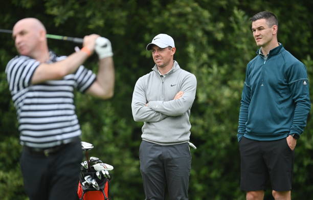Kilkenny , Ireland - 30 June 2021; Rory McIlroy of Northern Ireland, left, and Leinster and Ireland rugby captain Jonathan Sexton watch former...