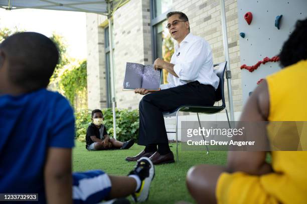 Health and Human Services Secretary Xavier Becerra reads a book to children in the Head Start early childhood education program at Martha's Table at...