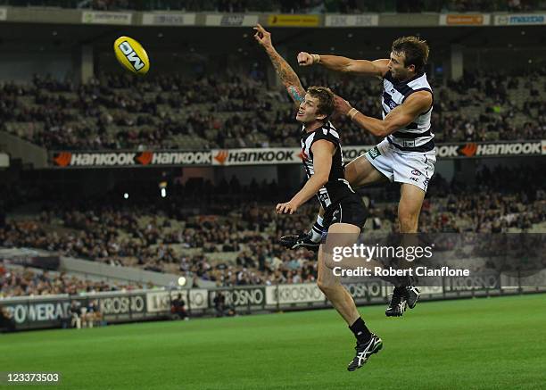 Dayne Beams of the Magpies is challenged by Corey Enright of the cats during the round 24 AFL match between the Collingwood Magpies and the Geelong...