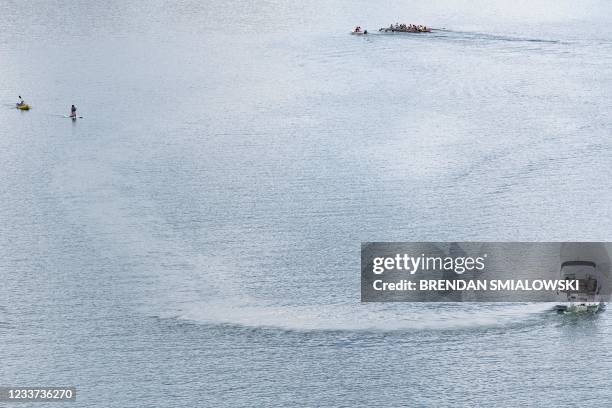 People are seen on the Potomac River as the DC area experiences a heatwave June 30 in Washington, DC. - Climate change is causing record-setting...