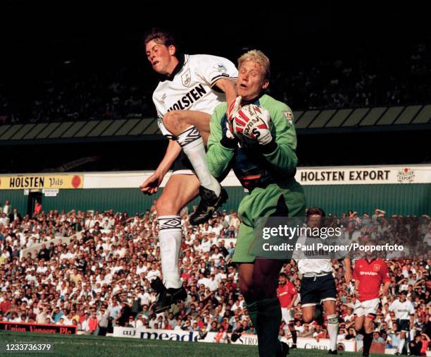 Manchester United goalkeeper Peter Schmeichel claims the ball under pressure from Darren Anderton of Tottenham Hotspur during an FA Carling...