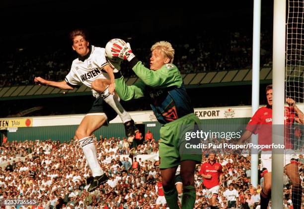 Manchester United goalkeeper Peter Schmeichel claims the ball under pressure from Darren Anderton of Tottenham Hotspur during an FA Carling...