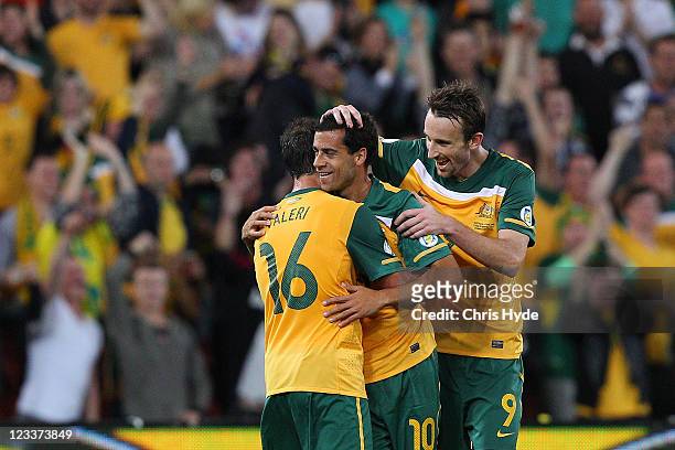 Alex Brosque of the Socceroos celebrates a goal with teamates Carl Valeri and Josh Kennedy during the Asian Qualifying 2014 FIFA World Cup match...