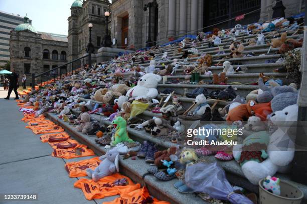 Toys and shoes placed to honour Indigenous children buried at Kamloops residential school are seen outside the British Columbia Parliament Building...