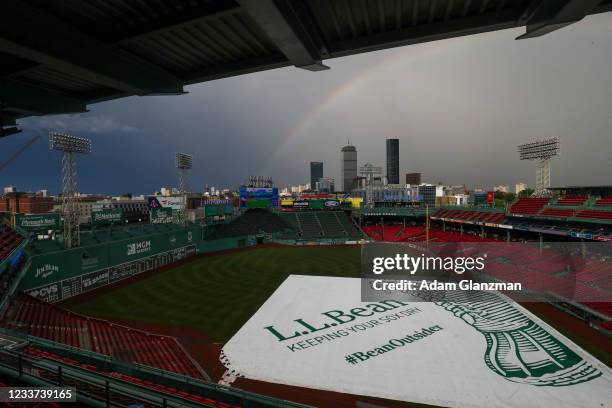 General view as a rainbow appears during a rain delay before a game between the Boston Red Sox and the Kansas City Royals at Fenway Park on June 30,...