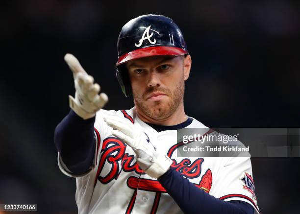 Freddie Freeman of the Atlanta Braves reacts after hitting an RBI single in the fourth inning of an MLB game against the New York Mets at Truist Park...