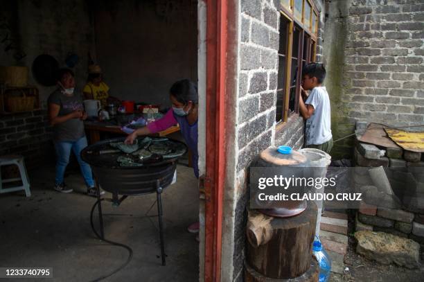 Gris , a member of the collective Mujeres de la Tierra , makes Mexican traditional tortillas in Milpa Alta, Mexico City, on June 21, 2021. - Mujeres...