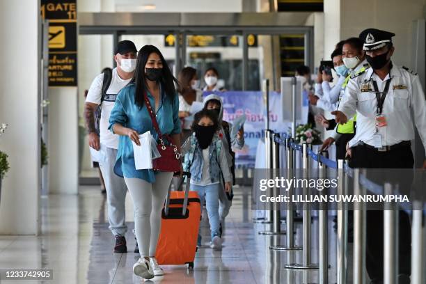 Passengers from an Etihad Airways flight from Abu Dhabi arrive at Phuket International Airport in Phuket on July 1 as the Phuket Sandbox tourism...