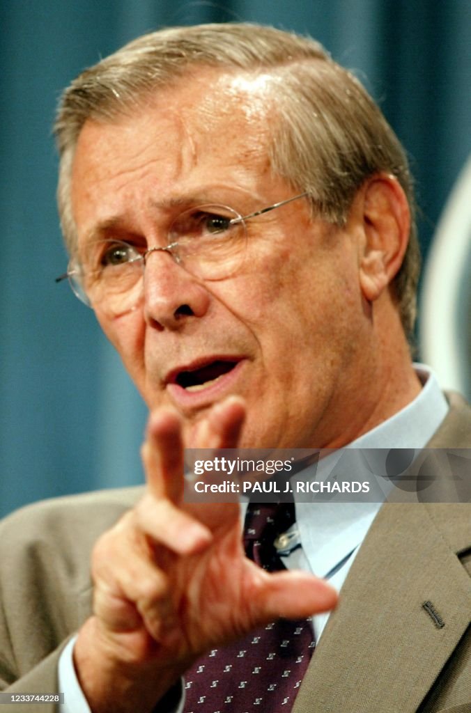John Rumsfeld US Secretary of Defense Donald H. Rumsfeld gestures to reporters as ...
