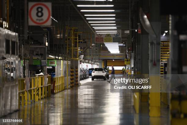 Nissan employees make final checks to cars on the production line at Nissan's plant in Sunderland, north east England on July 1, 2021. - Japanese...