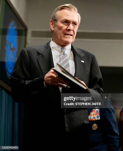 Secretary of Defense Donald Rumsfeld prepares to brief the media at the Pentagon 21 March 2003 in Washington, DC. Rumsfeld advised that the main air...