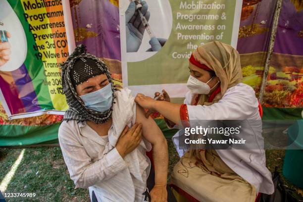 Kashmiri transgender person receives the COVID-19 vaccine shot during a camp at a park on June 30 in Srinagar, the summer capital of Indian...