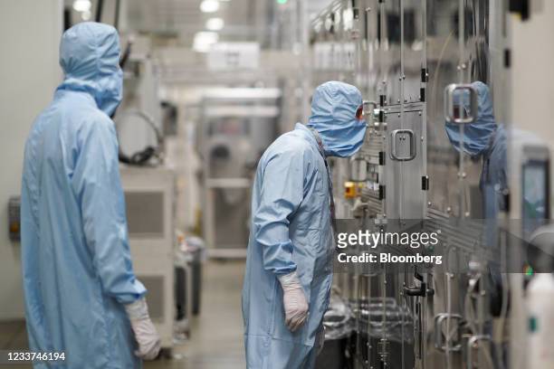 Employees monitor production at the Envision AESC Holding Ltd. Battery manufacturing facility inside the Nissan Motor Co. Plant in Sunderland, U.K.,...