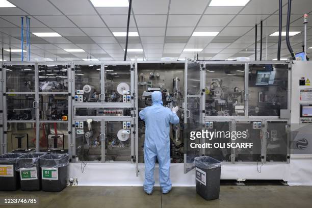 Employees work at the Envision battery manufacturing plant for the Nissan Leaf car at Nissan's plant in Sunderland, north east England on July 1,...