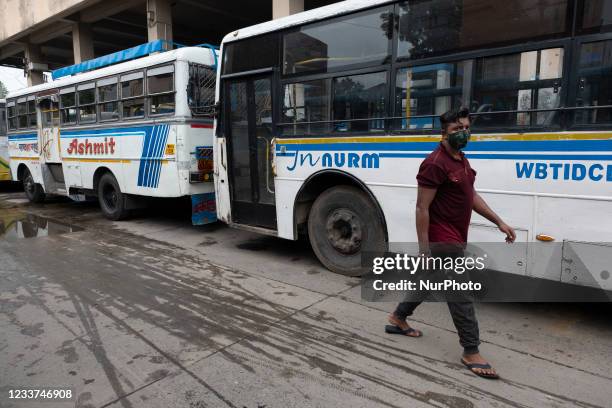 Man walking in the empty lane of a city bus terminus in Kolkata, India on July 1, 2021. West Bengal Govt has given certain restrictions on the...