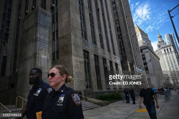 People walk past the Criminal Courts building and District Attorneys office in Manhattan,where long-serving chief financial officer of former...