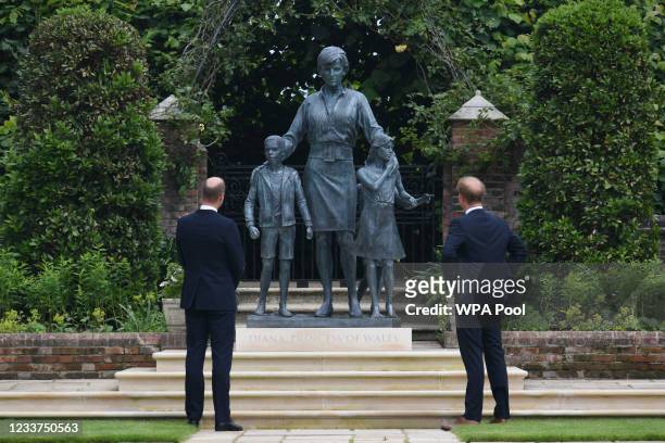 Prince William, Duke of Cambridge and Prince Harry, Duke of Sussex look at a statue they commissioned of their mother Diana, Princess of Wales, in...
