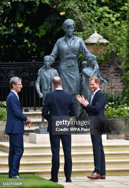 Prince William, Duke of Cambridge and Prince Harry, Duke of Sussex speak with Sculptor Ian Rank-Broadley after they unveiling a statue they...