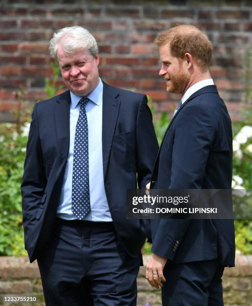 Britain's Prince Harry, Duke of Sussex chats with his uncle Earl Spencer ahead of the unveiling of a statue of their mother, Princess Diana at The...