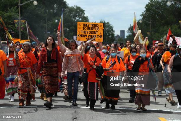 Demonstrators wearing orange in solidarity with survivors of residential schools march to Parliament Hill on Canada Day in Ottawa, Ontario, Canada,...