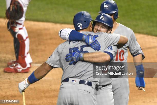 Max Muncy of the Los Angeles Dodgers celebrates hitting a grand slam in the fifth inning with Albert Pujols during a baseball game against the...