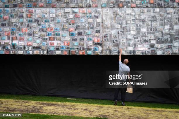 Visitor looks at a book on the side of the Big Ben Lying Down installation which was created by the artist Marta Minujín. The 42m replica of Big Ben...