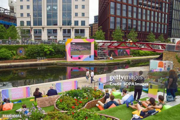 People are seen watching the Wimbledon tennis championship on an outdoor screen at Granary Square in King's Cross, London. Summer Love, a free...