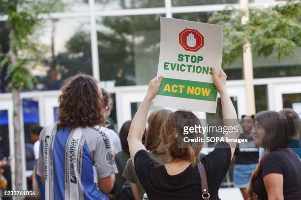 Woman holds a placard to stop evictions at a rally for housing reform. Columbus community members, activists and politicians all came out to support...