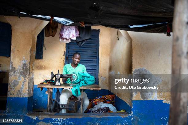 Freetown, SierraLeone Tailor in Bomeh Village on June 15, 2021 in Freetown, Sierra Leone. The poorest of the poor have started to settle on the waste...