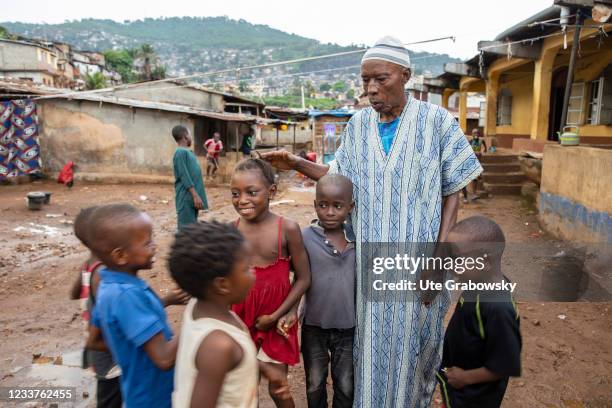 Freetown, SierraLeone Old and young in Bomeh Village on June 15, 2021 in Freetown, Sierra Leone. The poorest of the poor have started to settle on...