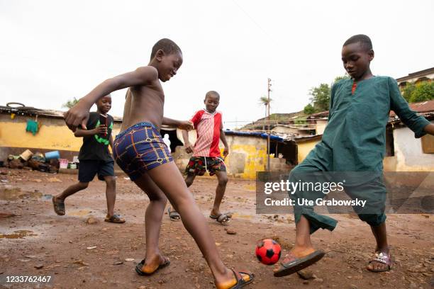 Freetown, SierraLeone Children playing foorball in Bomeh Village on June 15, 2021 in Freetown, Sierra Leone. The poorest of the poor have started to...