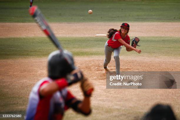 Young girl throws a pitch during amateur baseball games, amidst the Coronavirus pandemic, in the 23 de enero neighborhood in Caracas, Venezuela on...