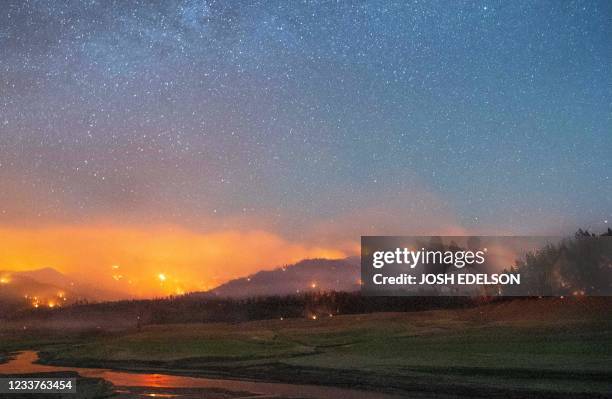 In this long exposure photograph, flames surround a drought-stricken Shasta Lake during the "Salt fire" in Lakehead, California early on July 2 as...