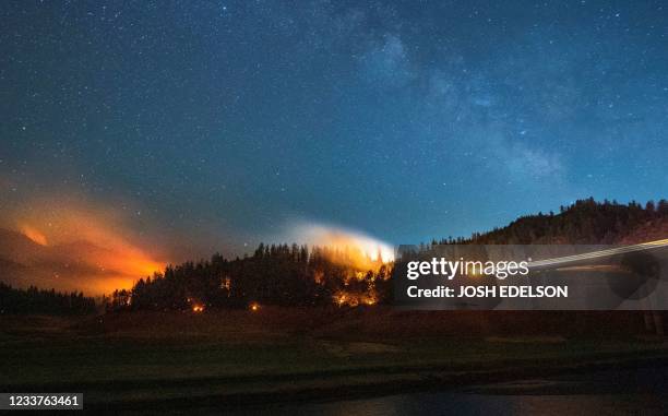 In this long exposure photograph, flames surround a drought-stricken Shasta Lake during the "Salt fire" in Lakehead, California early on July 2 as...