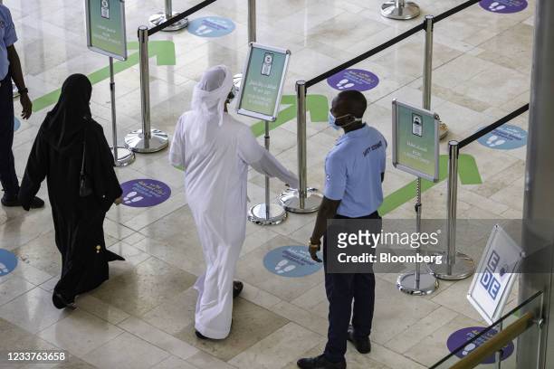 Visitors pass through social distancing measures at the entrance of Yas Mall, operated by Aldar Properties PJSC, in Abu Dhabi, United Arab Emirates,...