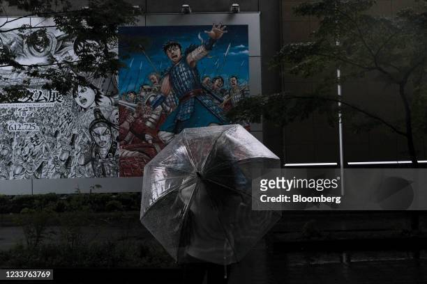 Visitor looks at the posters advertising an exhibition on the Japanese manga series "Kingdom" at the Ueno Royal Museum in the Ueno district of Tokyo,...
