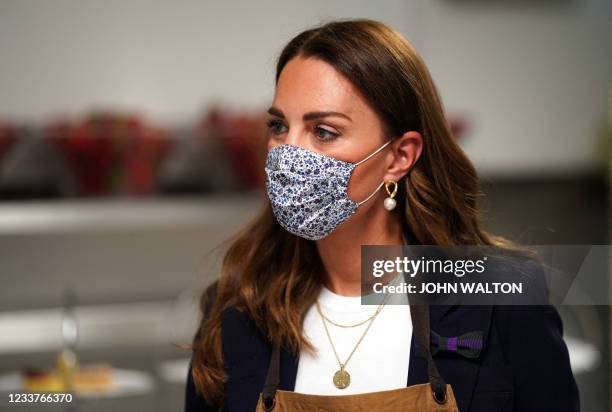 Britain's Catherine, Duchess of Cambridge, Patron of the All England Lawn Tennis Club, reacts during her visit on the fifth day of the 2021 Wimbledon...