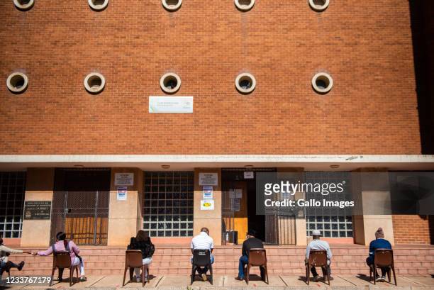 People wait in a queue at the Pretoria North Club Rendezvous vaccination site for educators and support staff on June 24, 2021 in Pretoria, South...