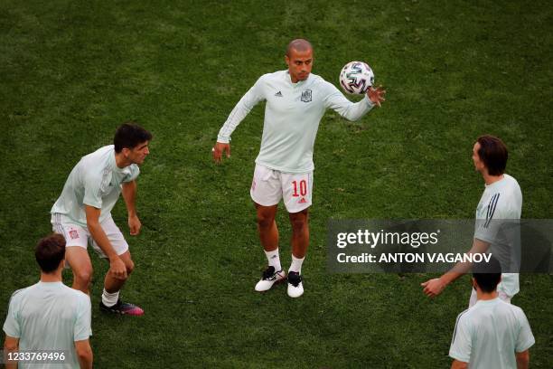 Spain's midfielder Thiago Alcantara warms up with teammates before the UEFA EURO 2020 quarter-final football match between Switzerland and Spain at...
