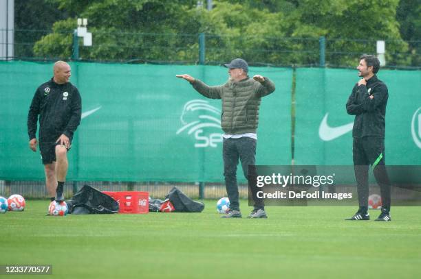 Assistant coach Kevin Hofland of VfL Wolfsburg, Director of sport Joerg Schmadtke of VfL Wolfsburg and head coach Mark van Bommel of VfL Wolfsburg...