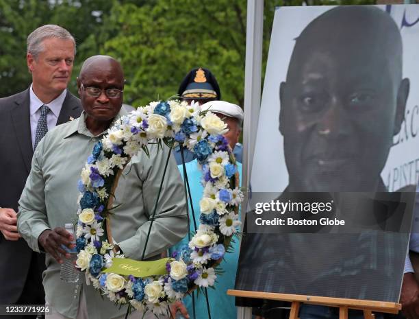 Winthrop, MA Aria "Ray" Green, brother of murdered retired Massachusetts State Trooper David L. Green, and Gov. Charlie Baker, left, stand next to a...