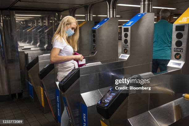 Commuter swipes a MetroCard to enter a subway station in New York, U.S., on Friday, July 2, 2021. New York's Metropolitan Transportation...